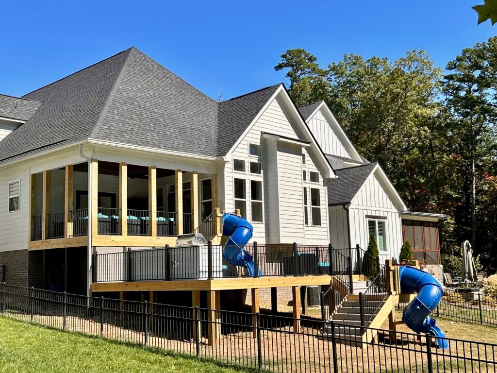 Custom backyard deck with slide built by Hunter Exteriors Chattanooga